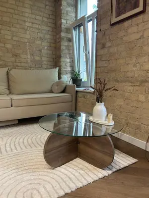 a living room with a glass table and a couch at Studio in Oldtown in Vilnius