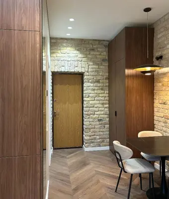 a hallway with a table and chairs and a door at Studio in Oldtown in Vilnius