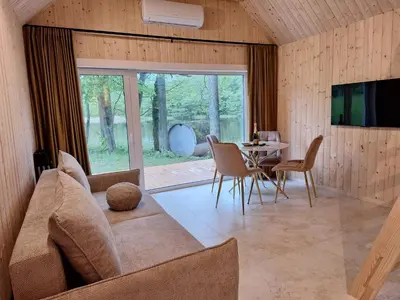 a living room with a couch and a table at Kiauklių oazė in Kiaukliai
