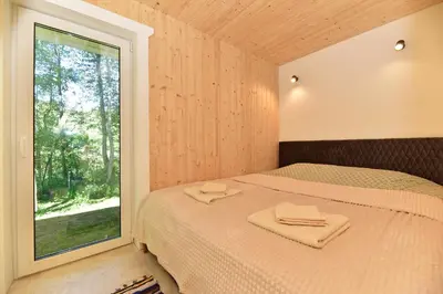 a bedroom with a bed with towels on it at Kiauklių oazė in Kiaukliai