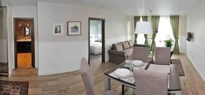 a living room with a dining table and a living room at Dzuku apartment 11 in Vilnius