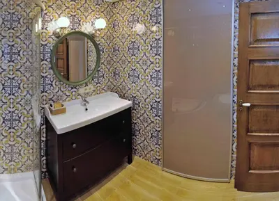 a bathroom with a sink and a mirror at Dzuku apartment 11 in Vilnius