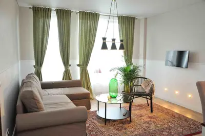 a living room with a couch and a table at Dzuku apartment 11 in Vilnius