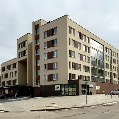 a large building with a parking lot in front of it at Dzuku apartment 11 in Vilnius