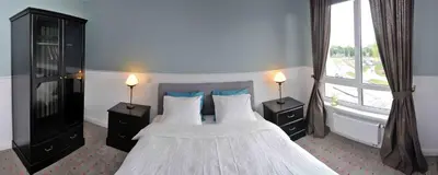 a bedroom with two beds and a window at Dzuku apartment 11 in Vilnius