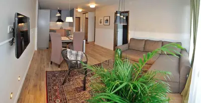 a living room with a couch and a table at Dzuku apartment 11 in Vilnius