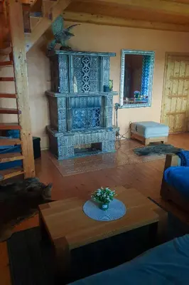 a living room with a fireplace and a table at Lake 4U in Užuguostis