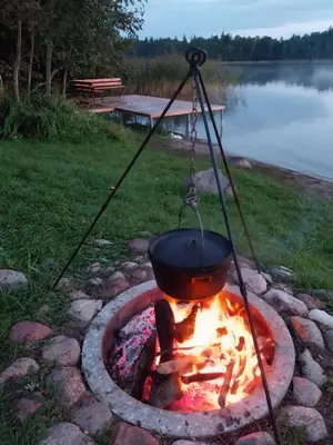 a pot over a fire in a fire pit at Lake 4U in Užuguostis