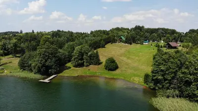 an aerial view of a small island in the middle of a lake at Lake 4U in Užuguostis