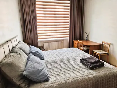 a bedroom with a bed with a suitcase on it at Boulevard house in Šiauliai