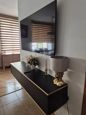 a table with a lamp on it in a room at Boulevard house in Šiauliai
