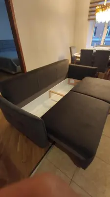 a living room with a couch and a table at Boulevard house in Šiauliai