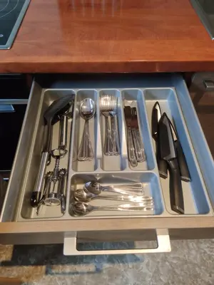a tray filled with utensils in a sink at Boulevard house in Šiauliai