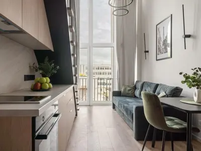 a kitchen and living room with a couch and a table at Loft 62 in Vilnius