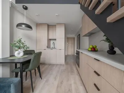 a kitchen with a table and a dining room at Loft 62 in Vilnius