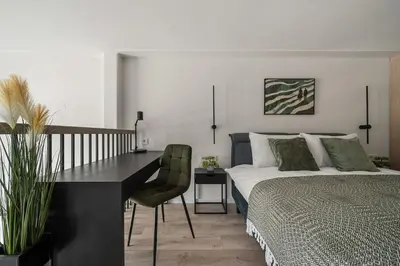 a bedroom with a bed and a desk and a desk at Loft 62 in Vilnius