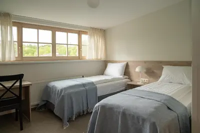 a hotel room with two beds and a window at Birštono Banginukas poilsio namai in Birštonas