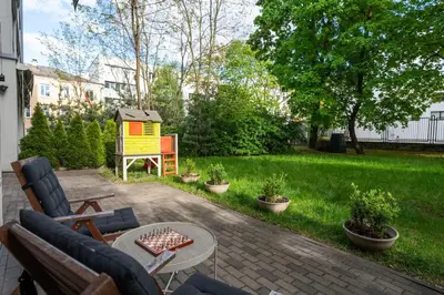a backyard with a garden with a bird house at Apartment with big terrace in Vilnius