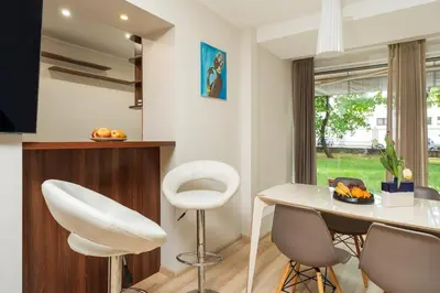 a dining room with a white table and chairs at Apartment with big terrace in Vilnius