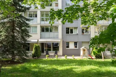 a building with a yard in front of it at Apartment with big terrace in Vilnius