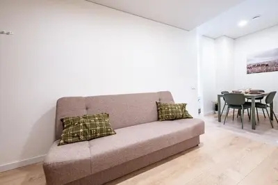 a living room with a couch and a table at Cozy 1BR in Old Town with FREE Parking in Vilnius