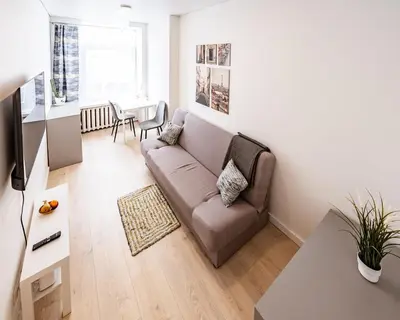 a living room with a couch and a table at Cozy 1BR in Old Town with FREE Parking in Vilnius