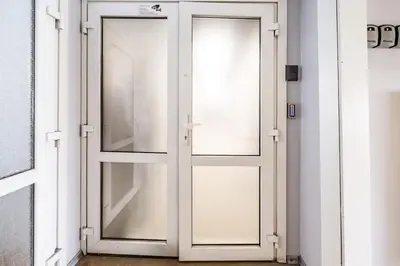 a white door with glass in a room at Cozy 1BR in Old Town with FREE Parking in Vilnius
