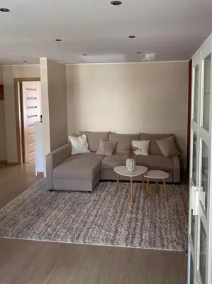 a living room with a couch and a table at Ramybė Druskininkai in Druskininkai