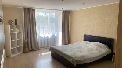 a bedroom with a bed and a large window at Ramybė Druskininkai in Druskininkai