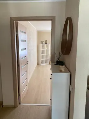 a hallway with a door leading into a room at Ramybė Druskininkai in Druskininkai