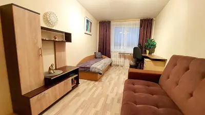 a living room with a couch and a bedroom at Central Apartment with Fireplace & Cathedral View in Šiauliai