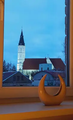 a view of a clock tower from a window at Central Apartment with Fireplace & Cathedral View in Šiauliai