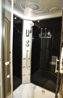a reflection of a shower in a bathroom mirror at Central Apartment with Fireplace & Cathedral View in Šiauliai