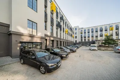 a row of cars parked in front of a building at Radio Apartment in Kaunas