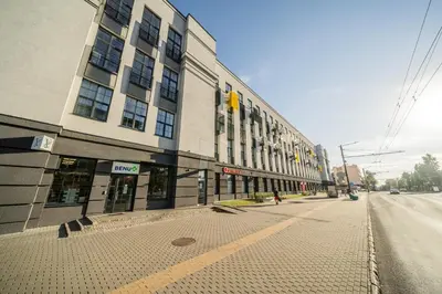 an empty street in front of a large building at Radio Apartment in Kaunas