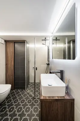 a bathroom with a white sink and a mirror at Radio Apartment in Kaunas