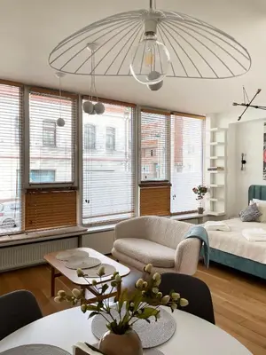 a living room with a bed and a couch at Cozy Vilnius Stay in Vilnius