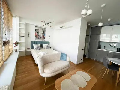 a living room with a couch and a table at Cozy Vilnius Stay in Vilnius