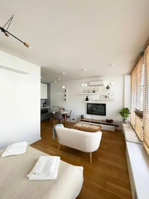a living room with a couch and a table at Cozy Vilnius Stay in Vilnius