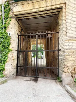 an open gate in a brick building with a door at Cozy Vilnius Stay in Vilnius