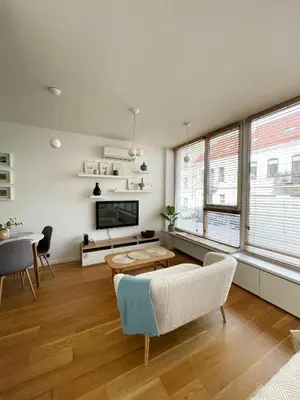 a living room with a couch and a table at Cozy Vilnius Stay in Vilnius