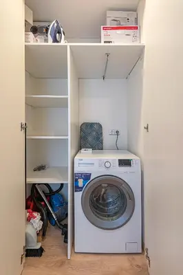a washer and dryer sitting inside of a closet at Luminious apartment with balcony by Polo Apartments in Kaunas