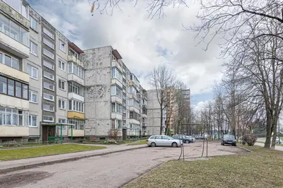 a parking lot with cars parked in front of a building at Luminious apartment with balcony by Polo Apartments in Kaunas