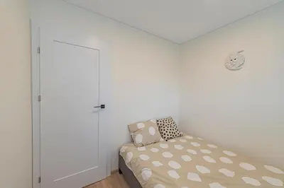 a small bedroom with a bed and a closet at Luminious apartment with balcony by Polo Apartments in Kaunas