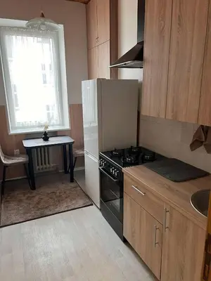 a kitchen with a stove and a sink and a table at Vytauto apartamentai centre in Kaunas