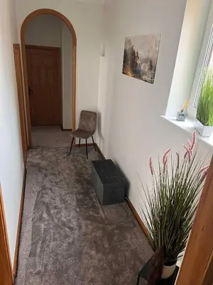 a hallway with a chair and a door and a chair sidx sidx sidx at Vytauto apartamentai centre in Kaunas