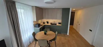 a kitchen with a table and chairs in a room at NEW Bright & Stylish 2BR apt in Vilnius