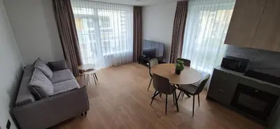 a living room with a couch and a table at NEW Bright & Stylish 2BR apt in Vilnius