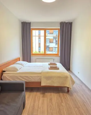 a bedroom with a bed and a window at Sv2 Marie Oldtown SELF CHECK-IN by QuarterStays in Vilnius