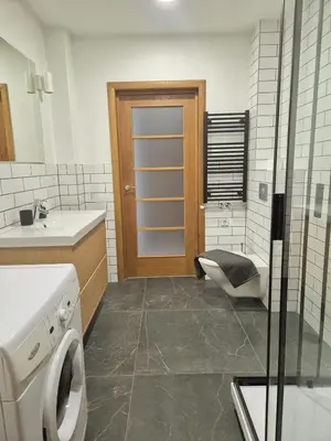 a bathroom with a toilet and a sink and a door at Sv2 Marie Oldtown SELF CHECK-IN by QuarterStays in Vilnius